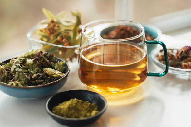 Steeping British herbal tea with teapot and fresh herbs